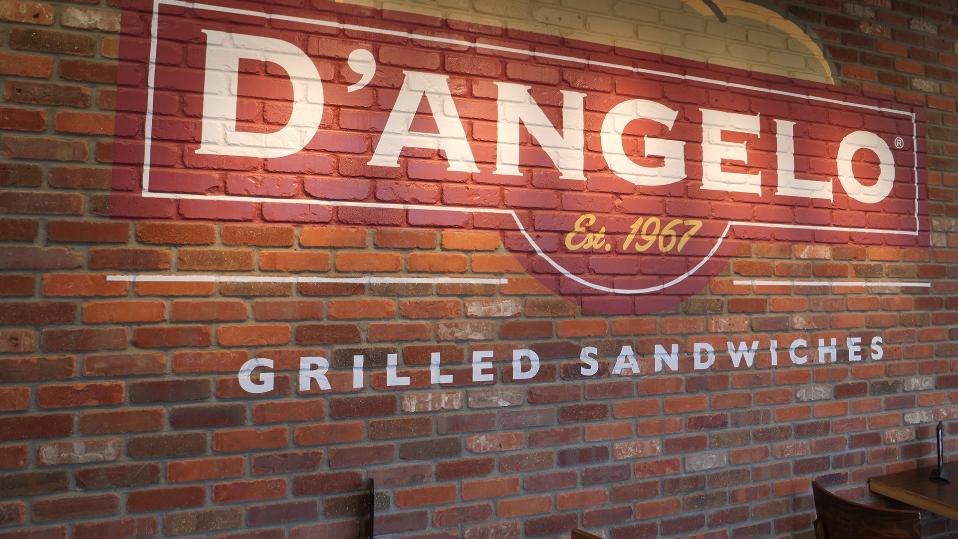 D'Angelos logo on brick wall